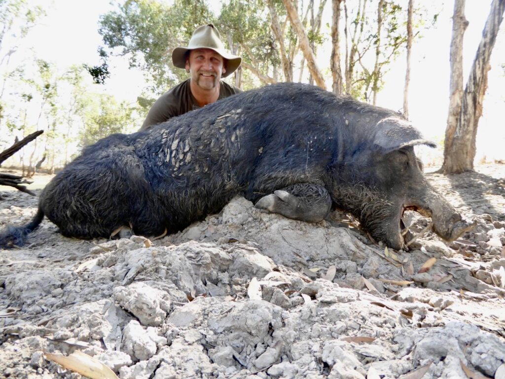 Hunter with a wild boar