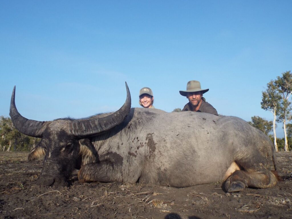 Hunters with a trophy buffalo on the floodplain